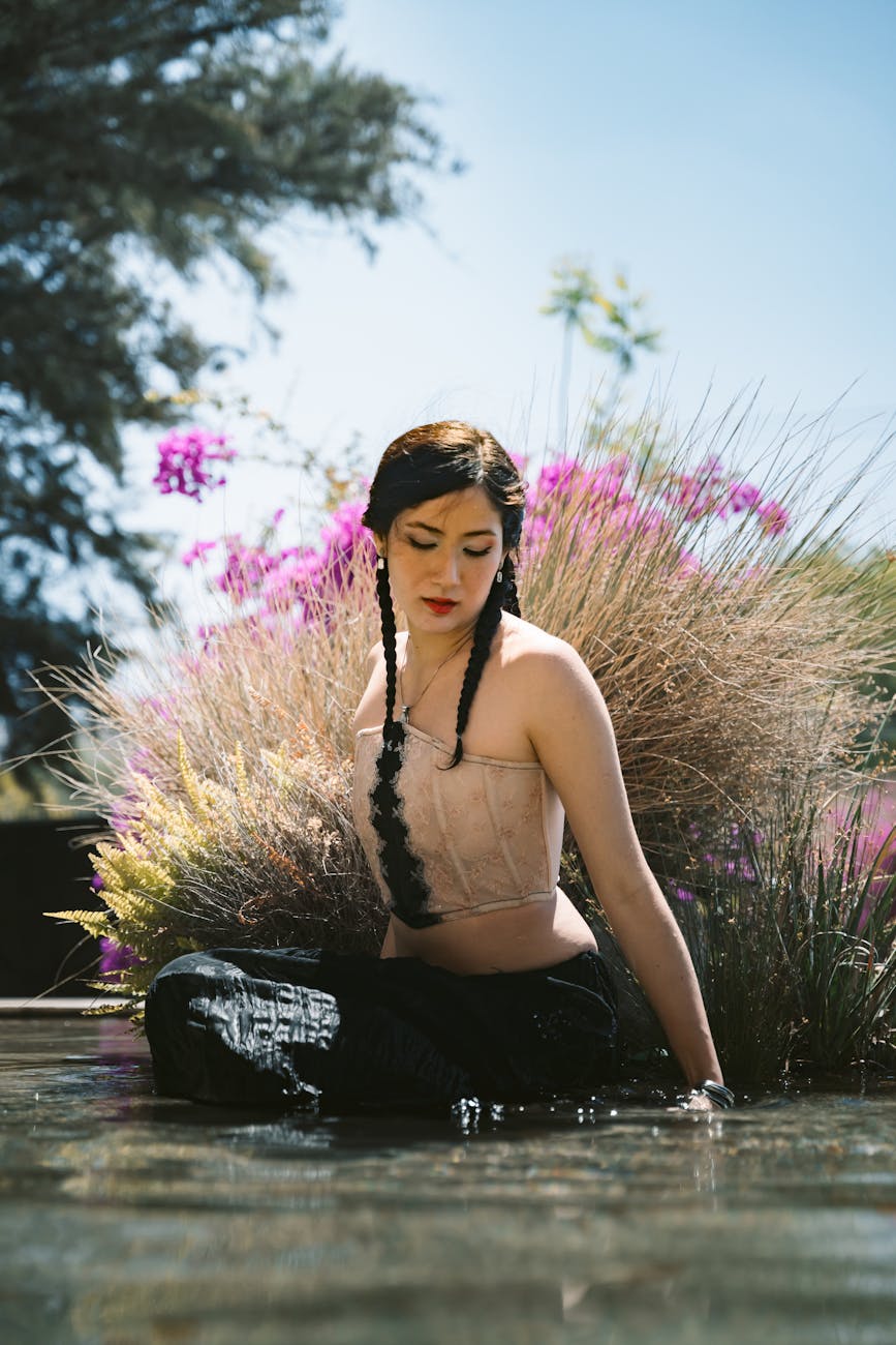 woman in water surrounded by vibrant foliage